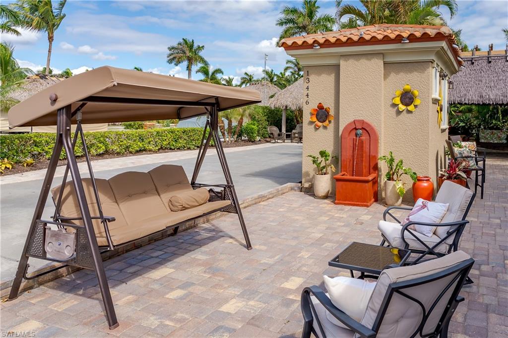 13446 Ladyfish Lane Naples, FL 34114 - Photo 17 of 44 a view of an chairs and tables in the patio