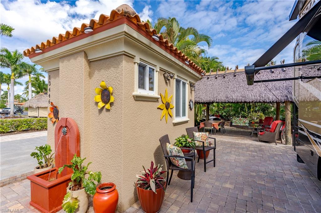 13446 Ladyfish Lane Naples, FL 34114 - Photo 18 of 44 a view of a chairs and table in the patio