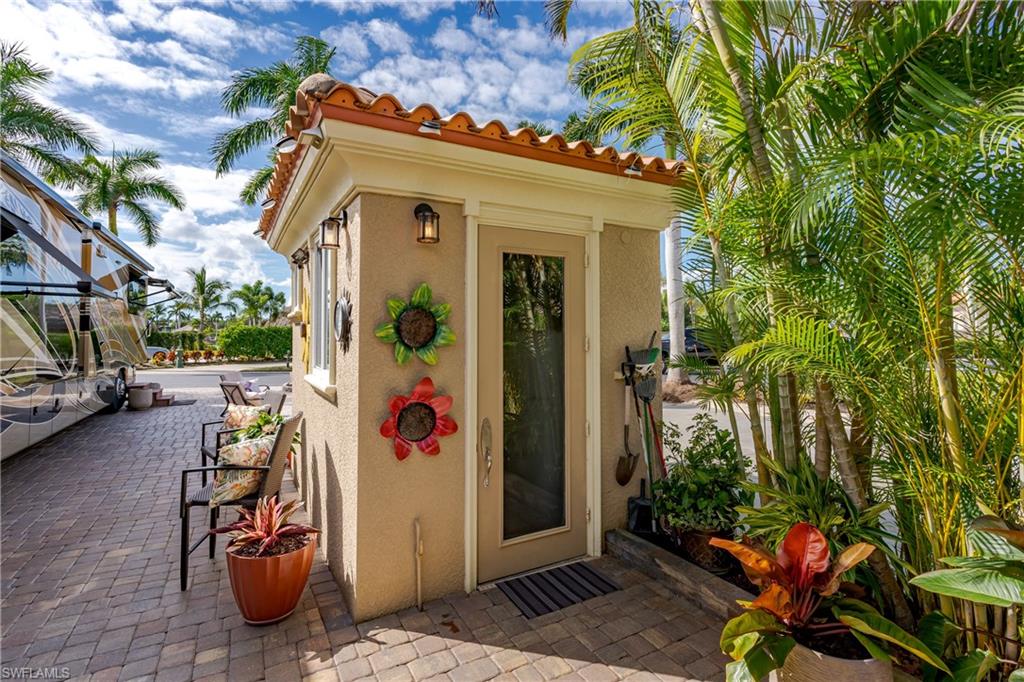 13446 Ladyfish Lane Naples, FL 34114 - Photo 20 of 44 a view of a chairs and table in a backyard