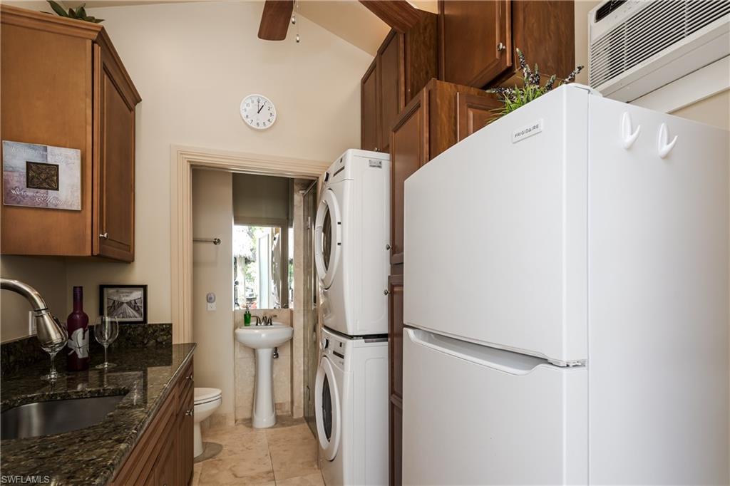 13446 Ladyfish Lane Naples, FL 34114 - Photo 22 of 44 a kitchen with a refrigerator and a sink