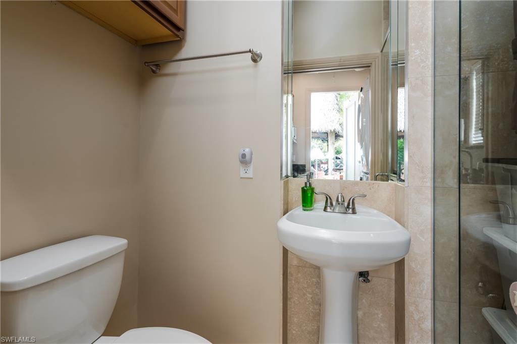 13446 Ladyfish Lane Naples, FL 34114 - Photo 25 of 44 a bathroom with a sink toilet and mirror