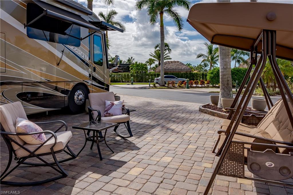 13446 Ladyfish Lane Naples, FL 34114 - Photo 28 of 44 a view of a patio with table and chairs and potted plants