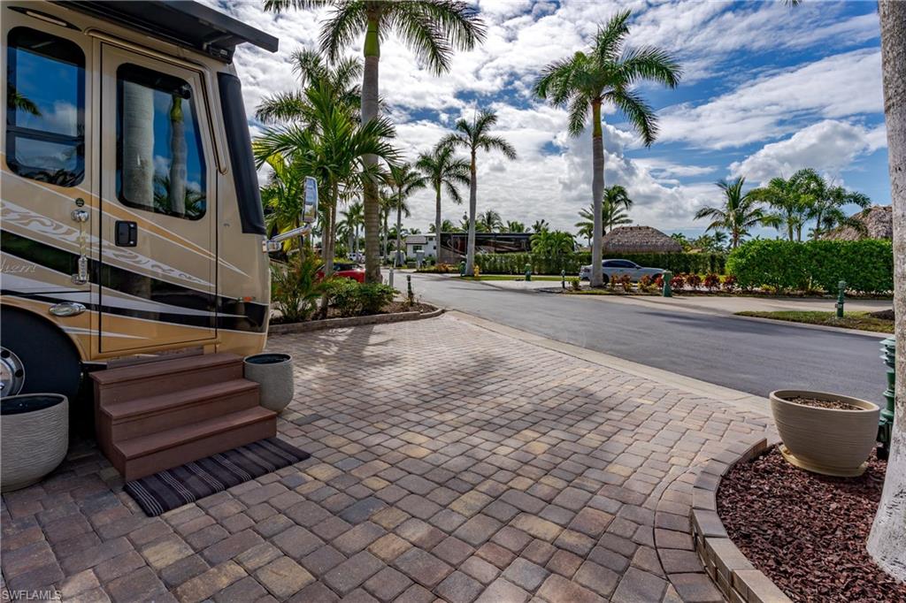 13446 Ladyfish Lane Naples, FL 34114 - Photo 29 of 44 a view of a backyard with sitting area