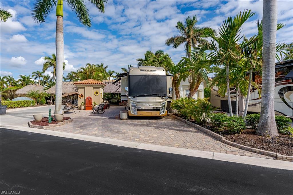 13446 Ladyfish Lane Naples, FL 34114 - Photo 31 of 44 a car parked on the side of a road