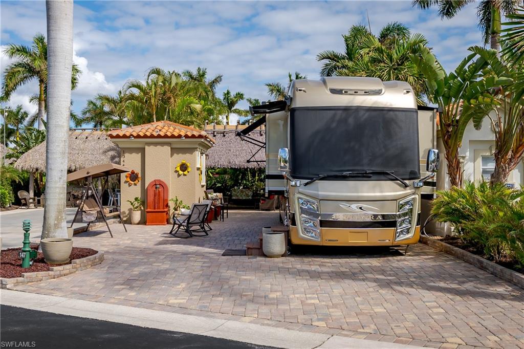 13446 Ladyfish Lane Naples, FL 34114 - Photo 34 of 44 a car parked in front of a building