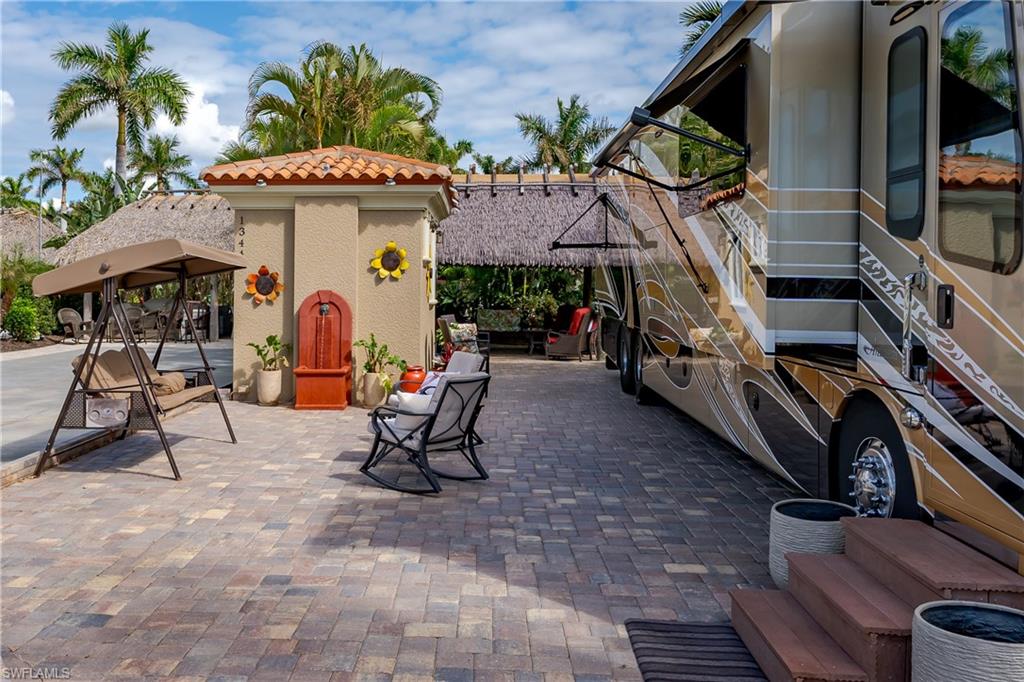 13446 Ladyfish Lane Naples, FL 34114 - Photo 36 of 44 a view of a chairs and table in a backyard