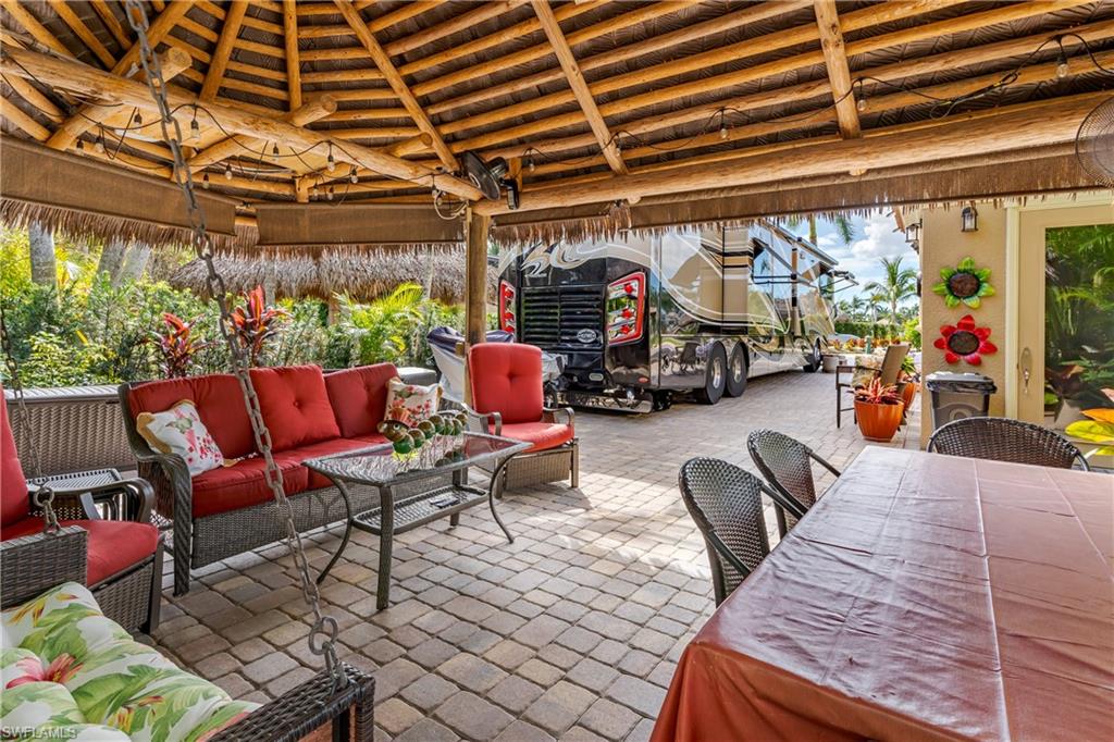 13446 Ladyfish Lane Naples, FL 34114 - Photo 9 of 44 a outdoor space with lots of furniture and a fireplace
