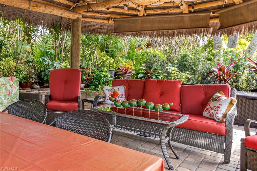 13446 Ladyfish Lane Naples, FL 34114 - Photo 10 of 44 a outdoor sitting area with furniture and a potted plant