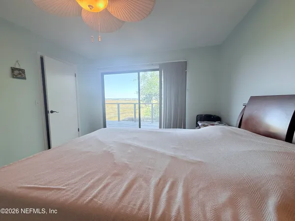 a bedroom with a bed and lamp