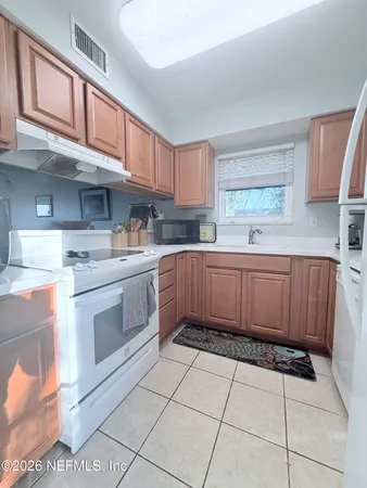 a kitchen with a stove a sink and a refrigerator