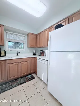 a kitchen with sink cabinets and window