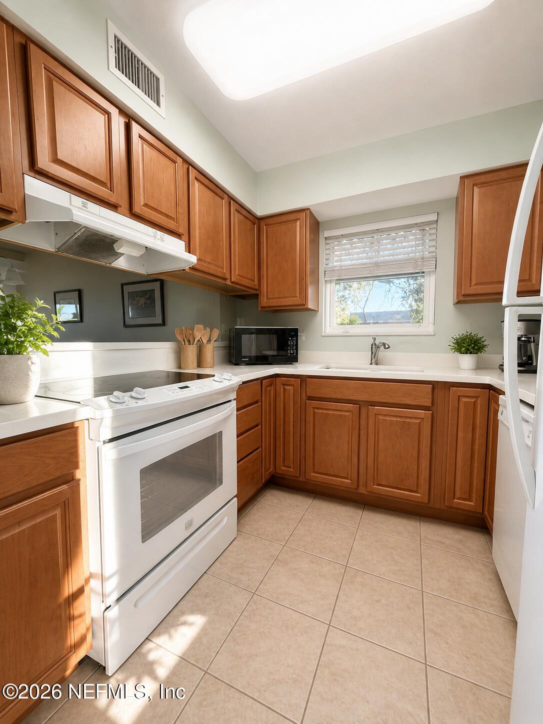 131 Rio Del Mar Street, Unit C St. Augustine, FL 32080 - Photo 3 of 14 a kitchen with a stove a sink and a microwave