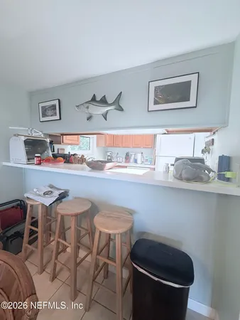 a room with a table chairs stove and cabinets