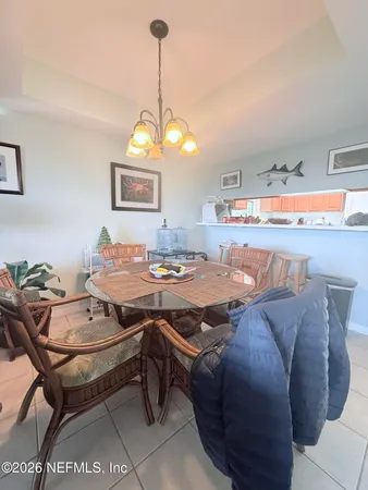 a living room with a table chairs and a wooden floor