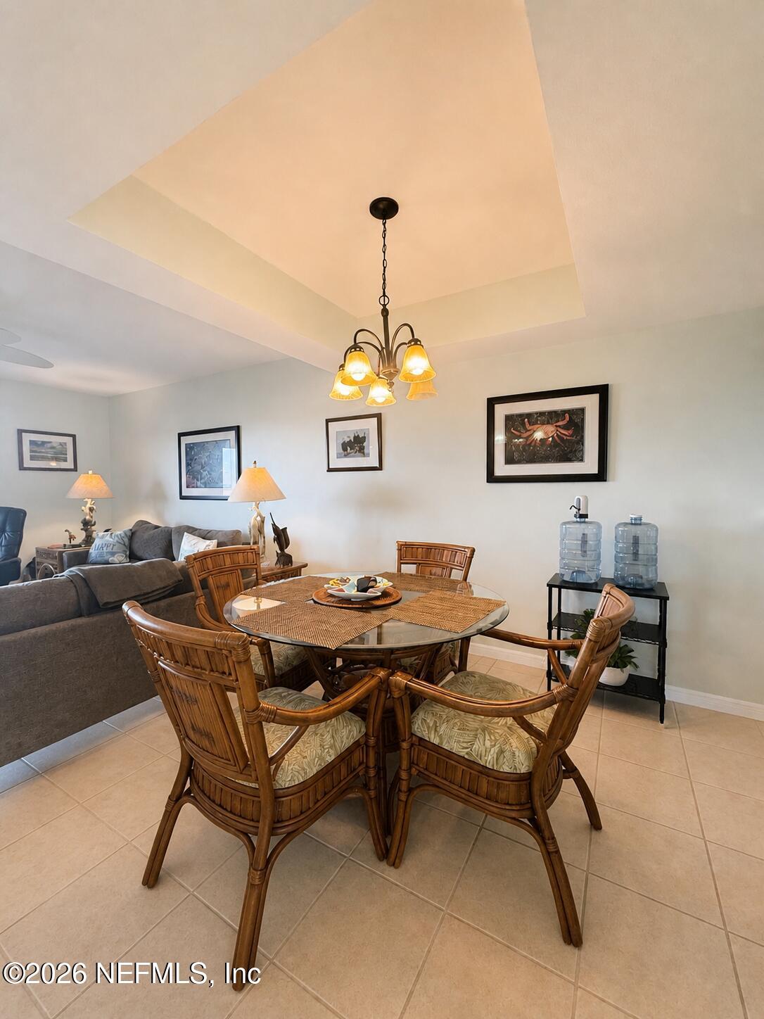131 Rio Del Mar Street, Unit C St. Augustine, FL 32080 - Photo 5 of 14 a living room with furniture a piano and a chandelier