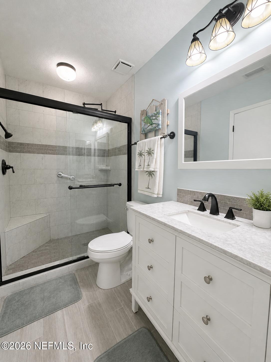 131 Rio Del Mar Street, Unit C St. Augustine, FL 32080 - Photo 9 of 14 a bathroom with a sink a toilet and shower