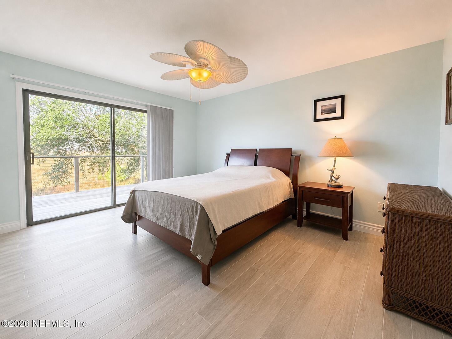 131 Rio Del Mar Street, Unit C St. Augustine, FL 32080 - Photo 10 of 14 a bedroom with a bed and a chandelier