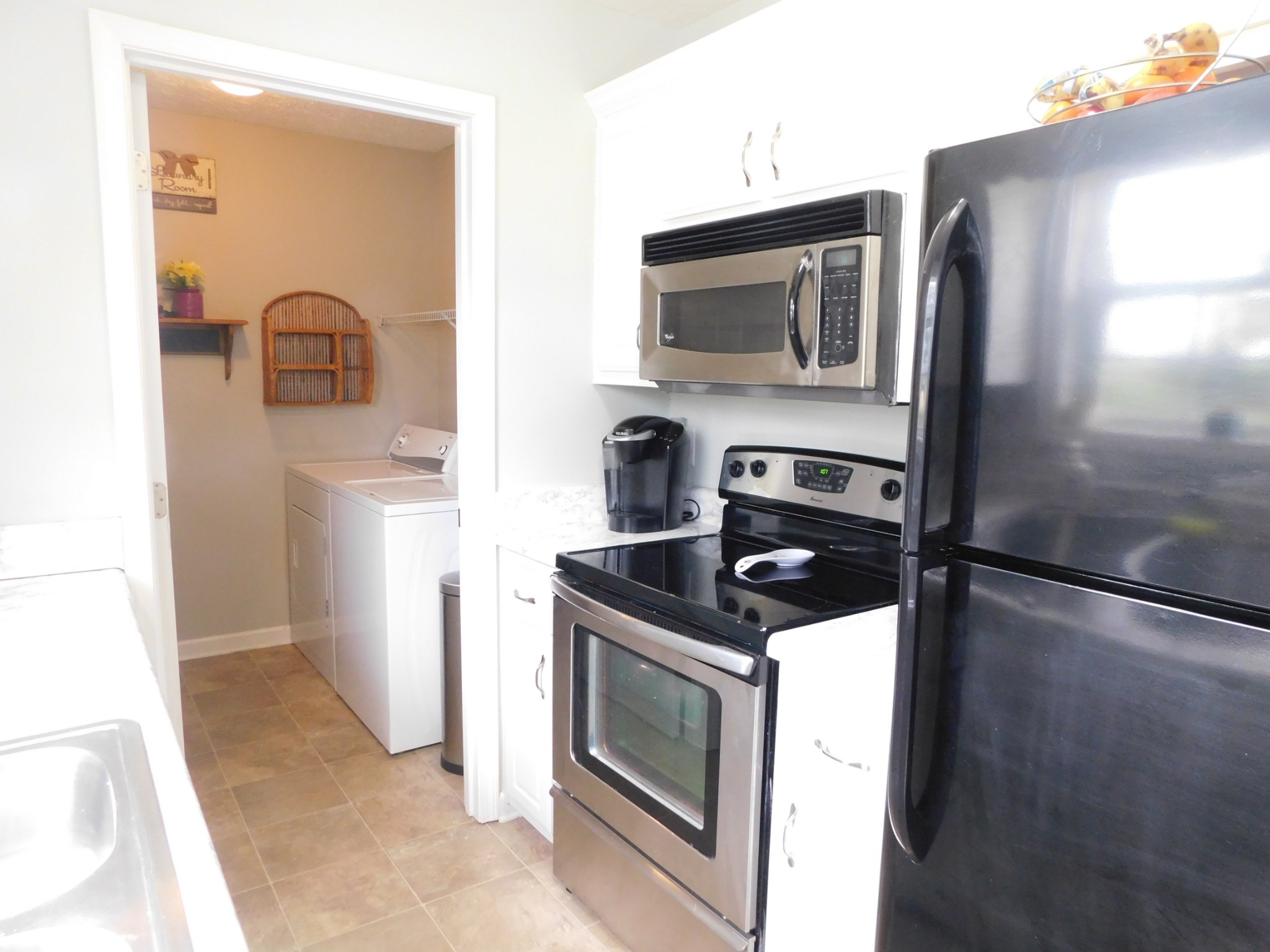 599 Jackson Road Portland, TN 37148 - Photo 12 of 39 a kitchen with granite countertop a refrigerator and a sink
