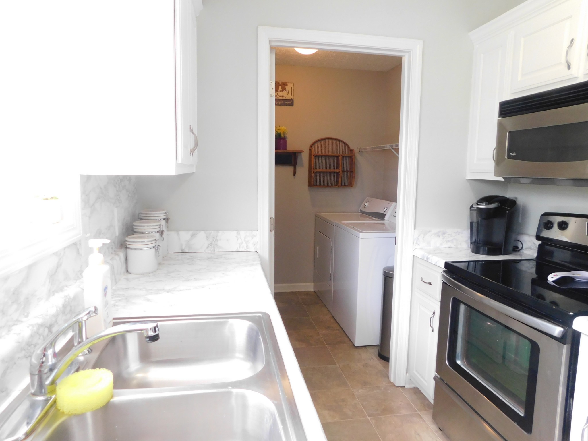 599 Jackson Road Portland, TN 37148 - Photo 14 of 39 a kitchen with a sink and a stove top oven with wooden floor