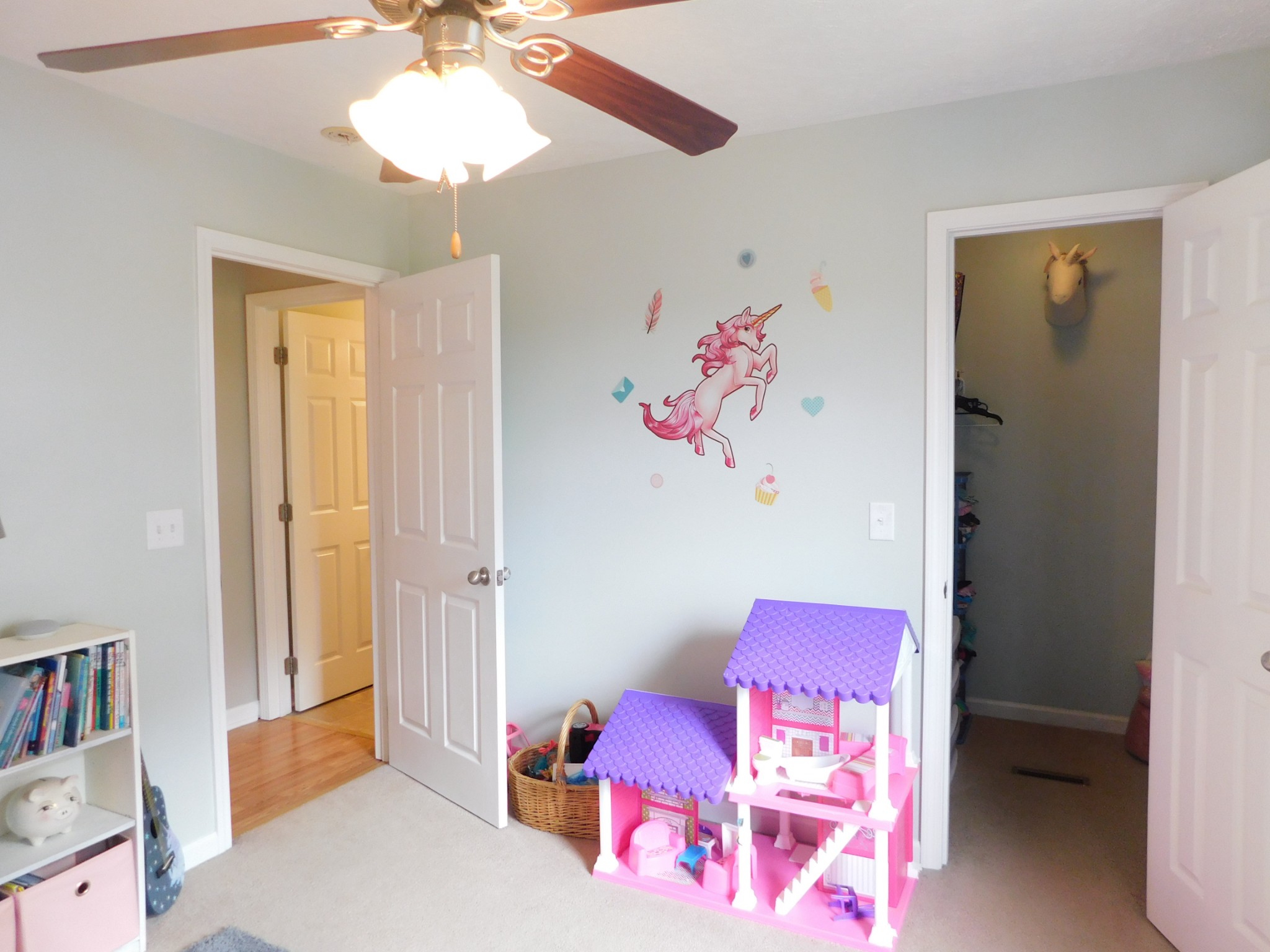 599 Jackson Road Portland, TN 37148 - Photo 21 of 39 a bedroom with a bed and a chandelier