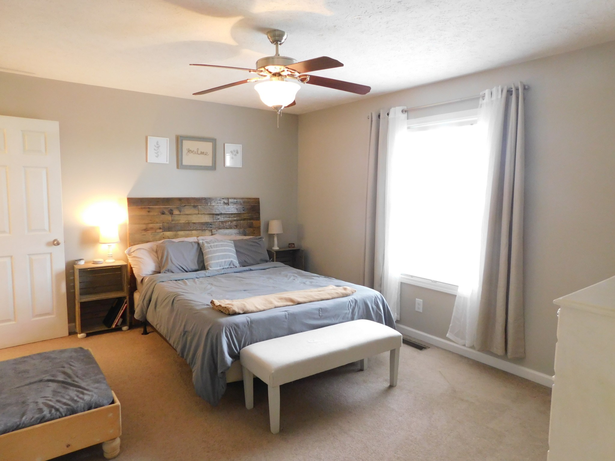 599 Jackson Road Portland, TN 37148 - Photo 26 of 39 a bedroom with a bed a chandelier and a window