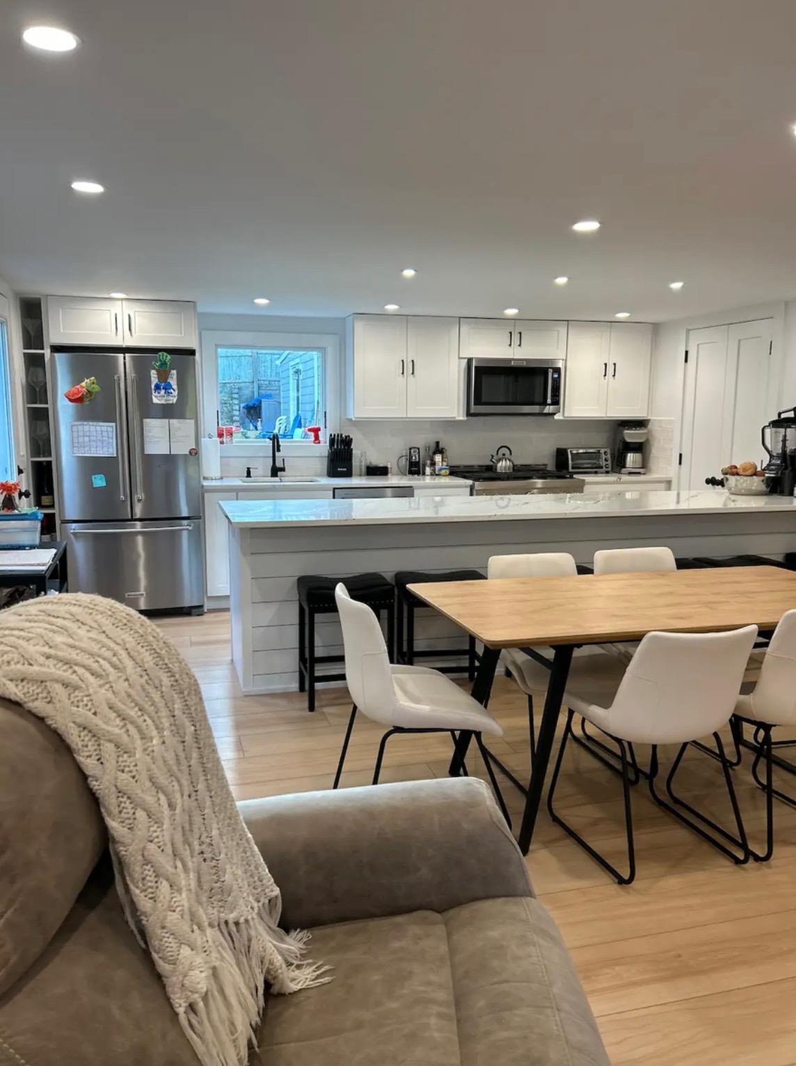 103 2nd House Road Montauk, NY 11954 - Photo 3 of 5 a living room with furniture a flat screen tv and kitchen view