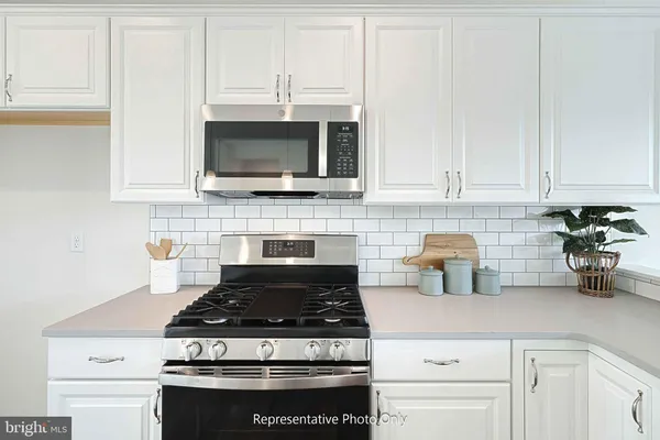 a stove top oven sitting inside of a kitchen