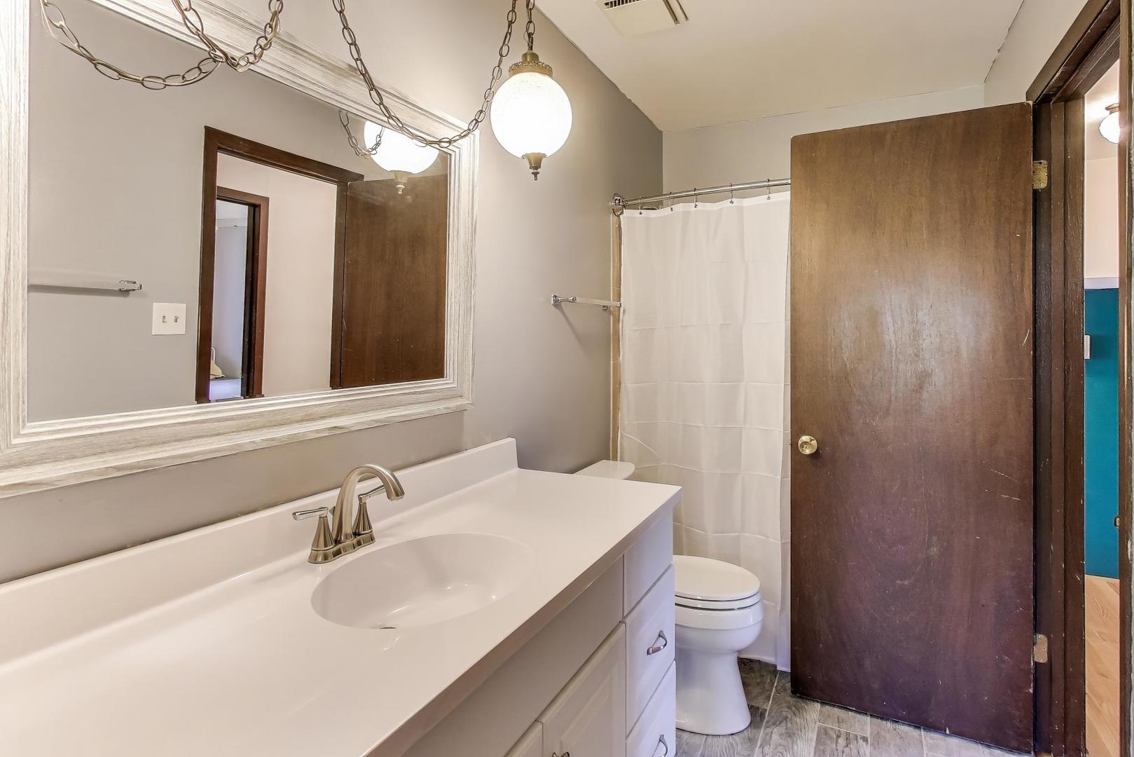 858 Academy Avenue Matteson, IL 60443 - Photo 12 of 20 a bathroom with a granite countertop sink toilet and shower