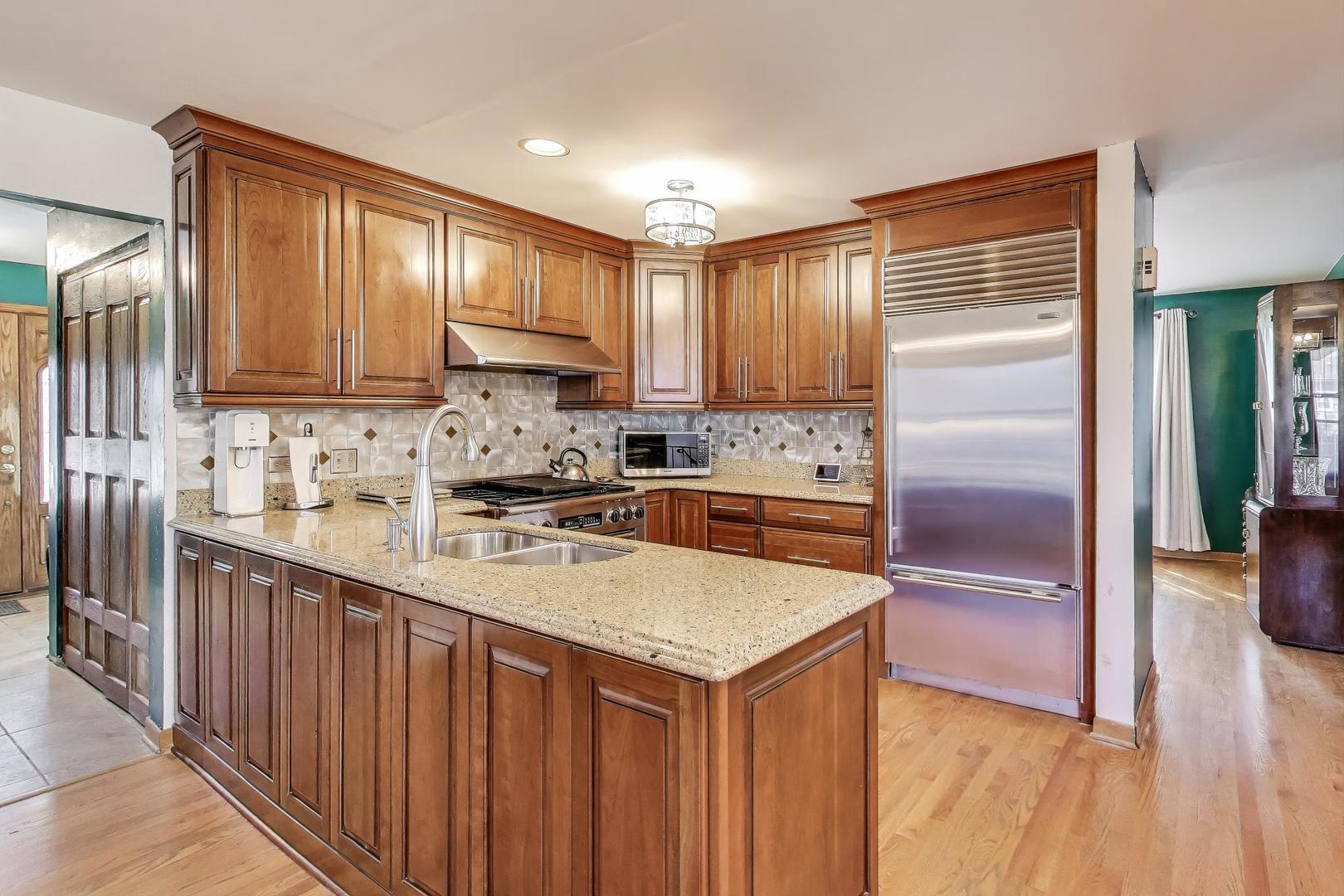 858 Academy Avenue Matteson, IL 60443 - Photo 7 of 20 a kitchen with stainless steel appliances granite countertop a stove a sink dishwasher and a refrigerator