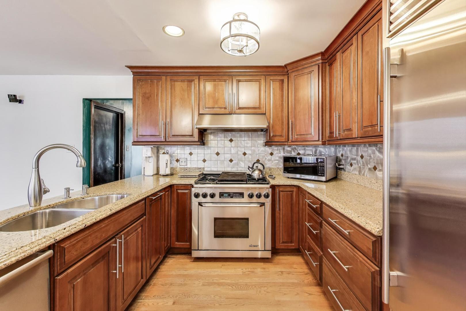 858 Academy Avenue Matteson, IL 60443 - Photo 8 of 20 a kitchen with stainless steel appliances granite countertop a stove a sink and a microwave