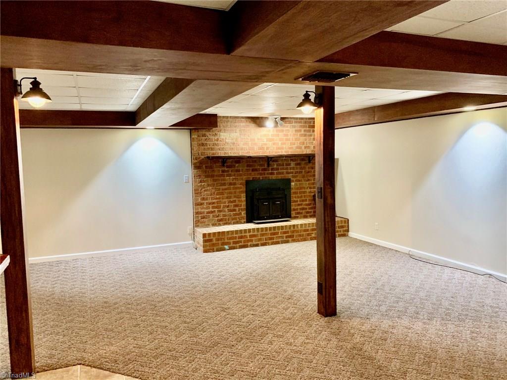 2029 Rowe Road Lexington, NC 27295 - Photo 21 of 30 Large basement gameroom w/ wood burning FP has a warm and cozy feel but large enough for hosting game night or holiday parties.