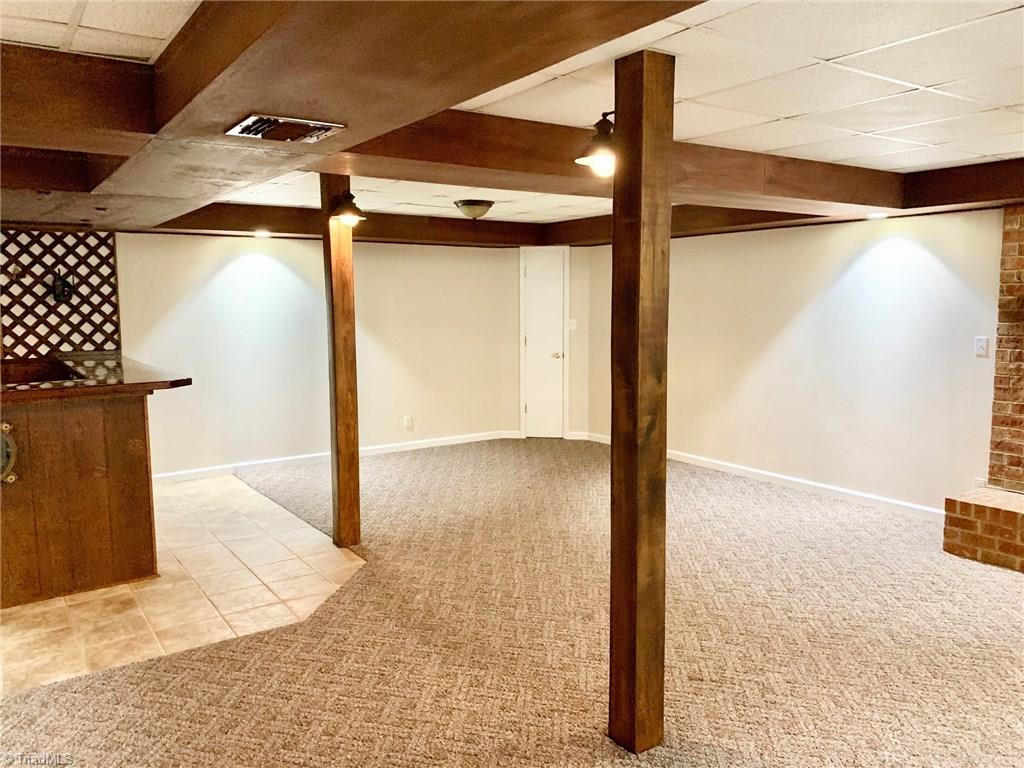 2029 Rowe Road Lexington, NC 27295 - Photo 22 of 30 Basement game room/den space offers so much great living space. Additionally, basement features a full bath. Options could include adding a bedroom. Septic system has been updated in 2019 for a 3 BR usage per seller.