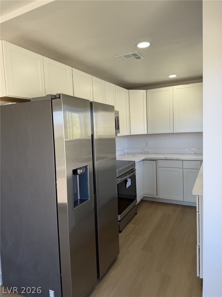 1 Carson Court Ely, NV 89301 - Photo 6 of 20 This modern kitchen features crisp cabinetry, sleek countertops, and essential appliances for comfortable living.
