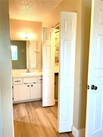 a bathroom with a granite countertop sink a mirror and a shower