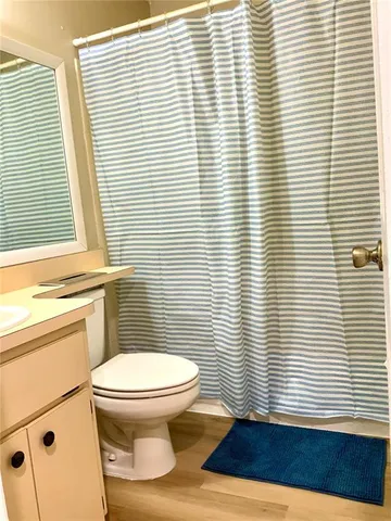 a bathroom with a sink a toilet and a window