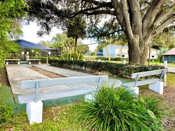 a view of a house with swimming pool and sitting area