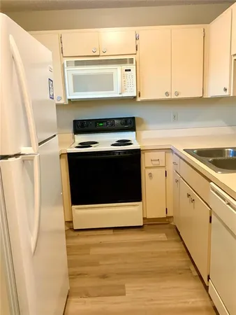 a kitchen with a stove and a white refrigerator