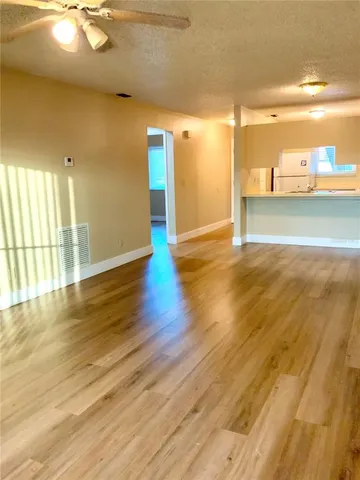 a view of a room with wooden floor