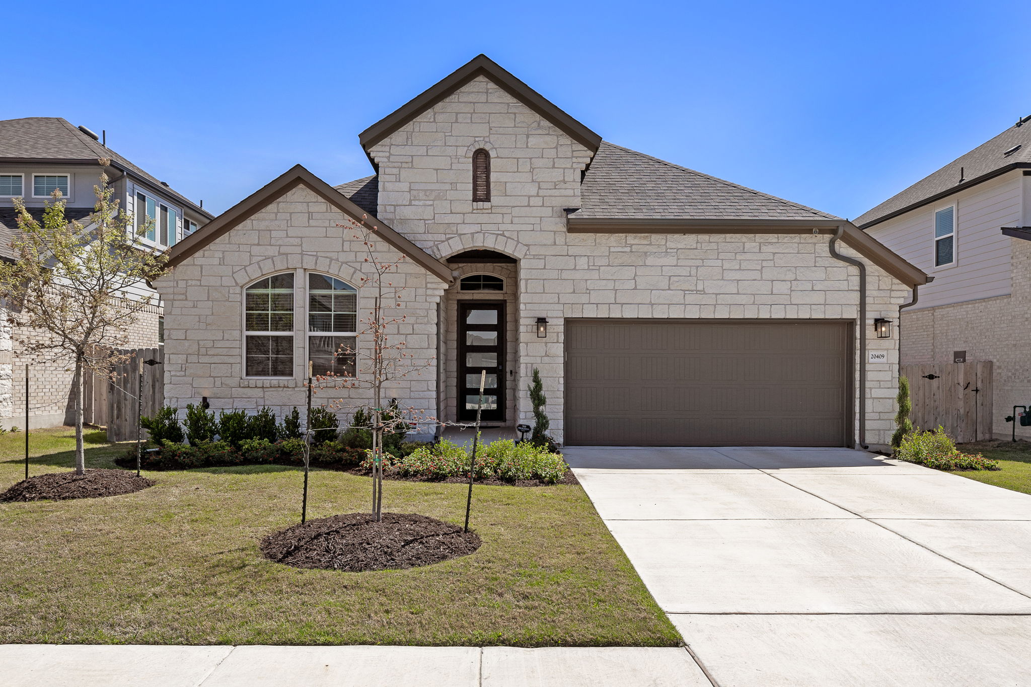 a front view of a house with a yard and garage