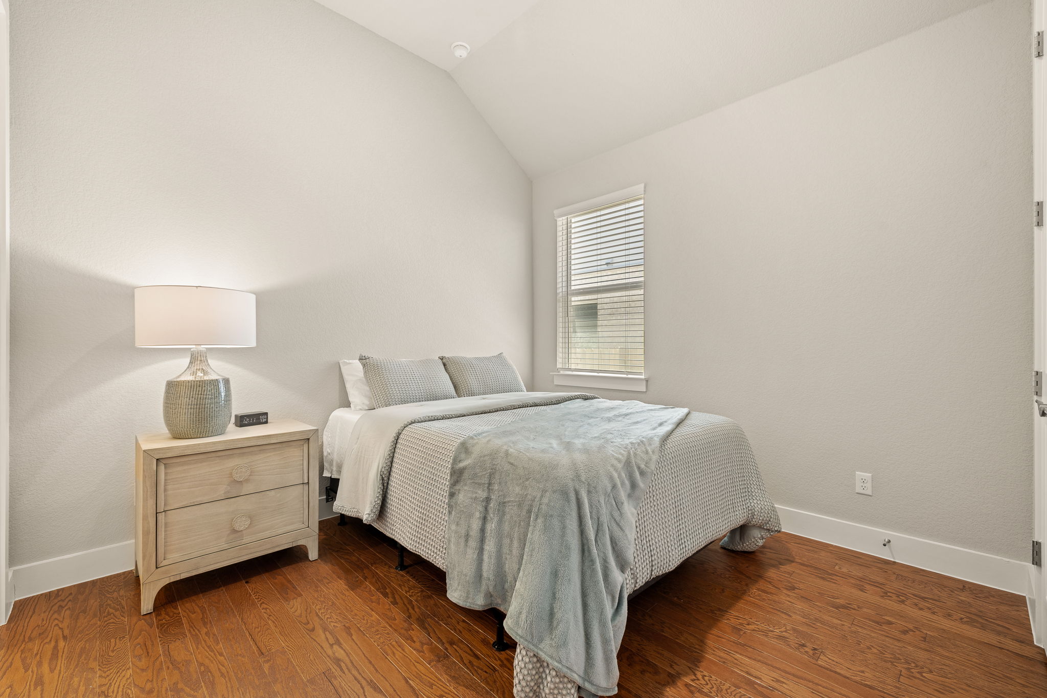 20409 Dustin Lane Pflugerville, TX 78660 - Photo 20 of 35 a bedroom with a bed and a night stand