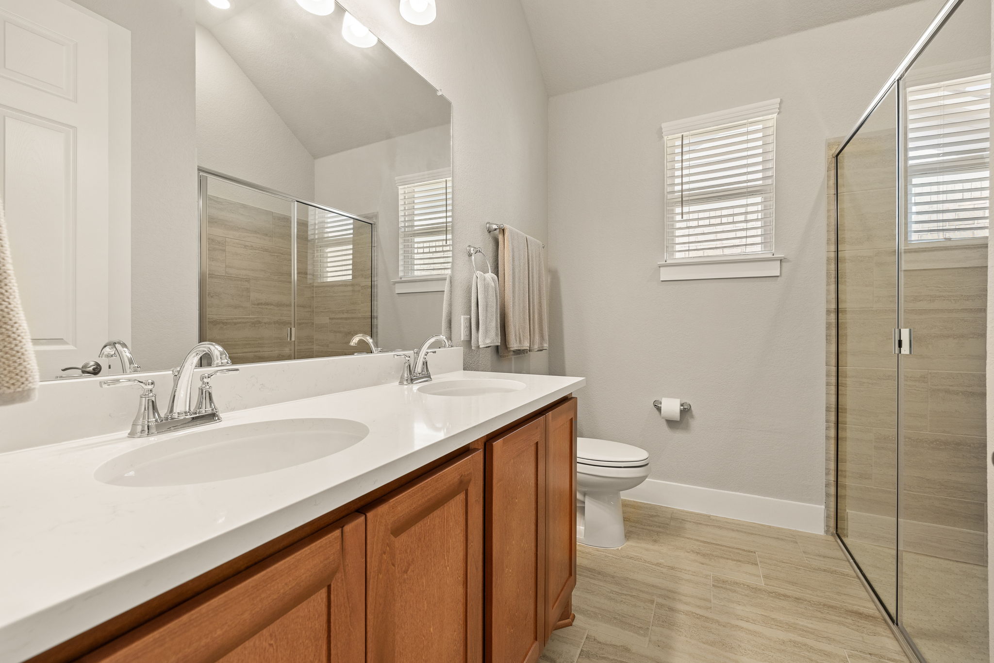 20409 Dustin Lane Pflugerville, TX 78660 - Photo 24 of 35 a bathroom with a granite countertop sink toilet and shower