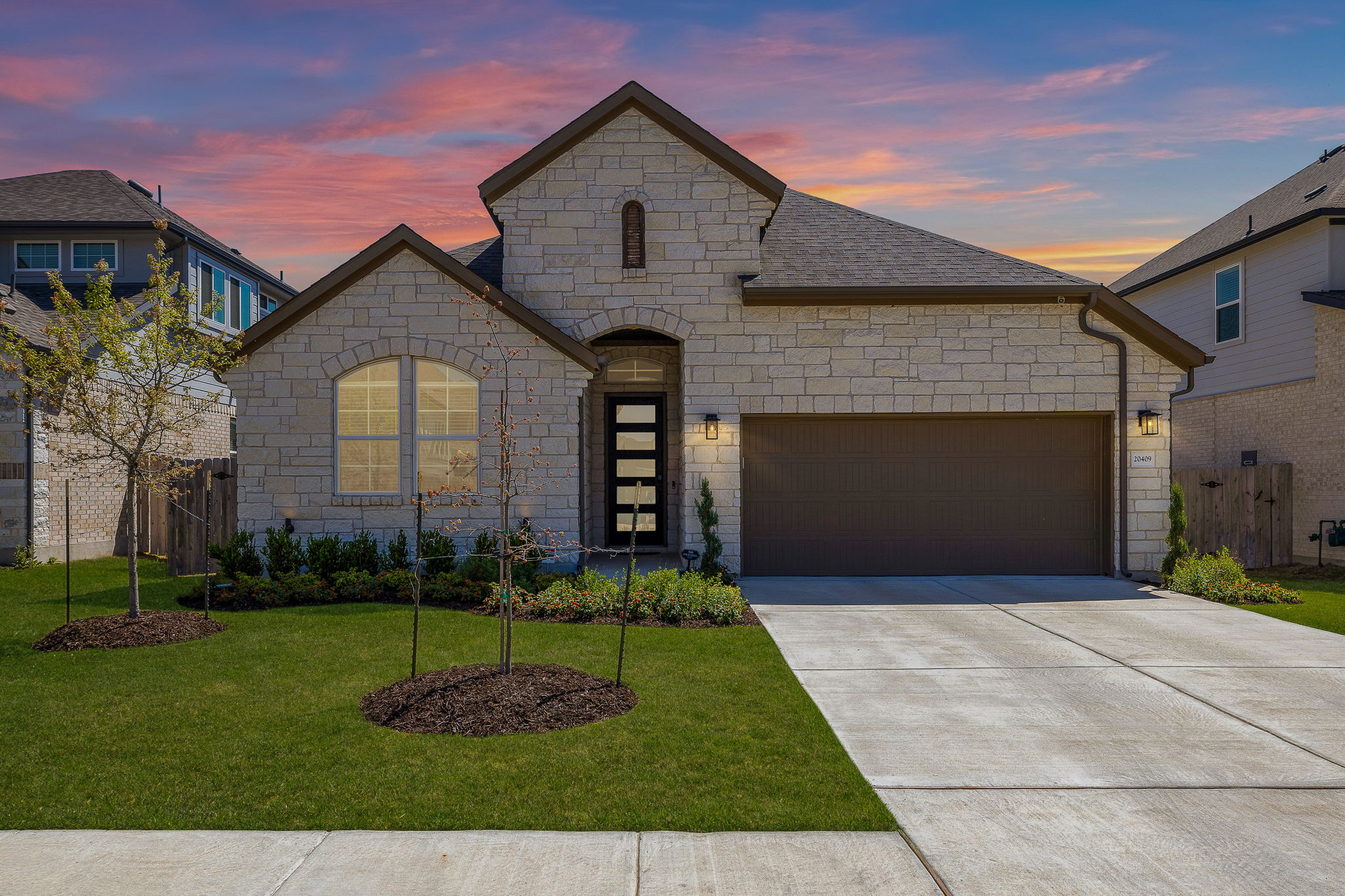 20409 Dustin Lane Pflugerville, TX 78660 - Photo 3 of 35 a front view of a house with a yard and garage