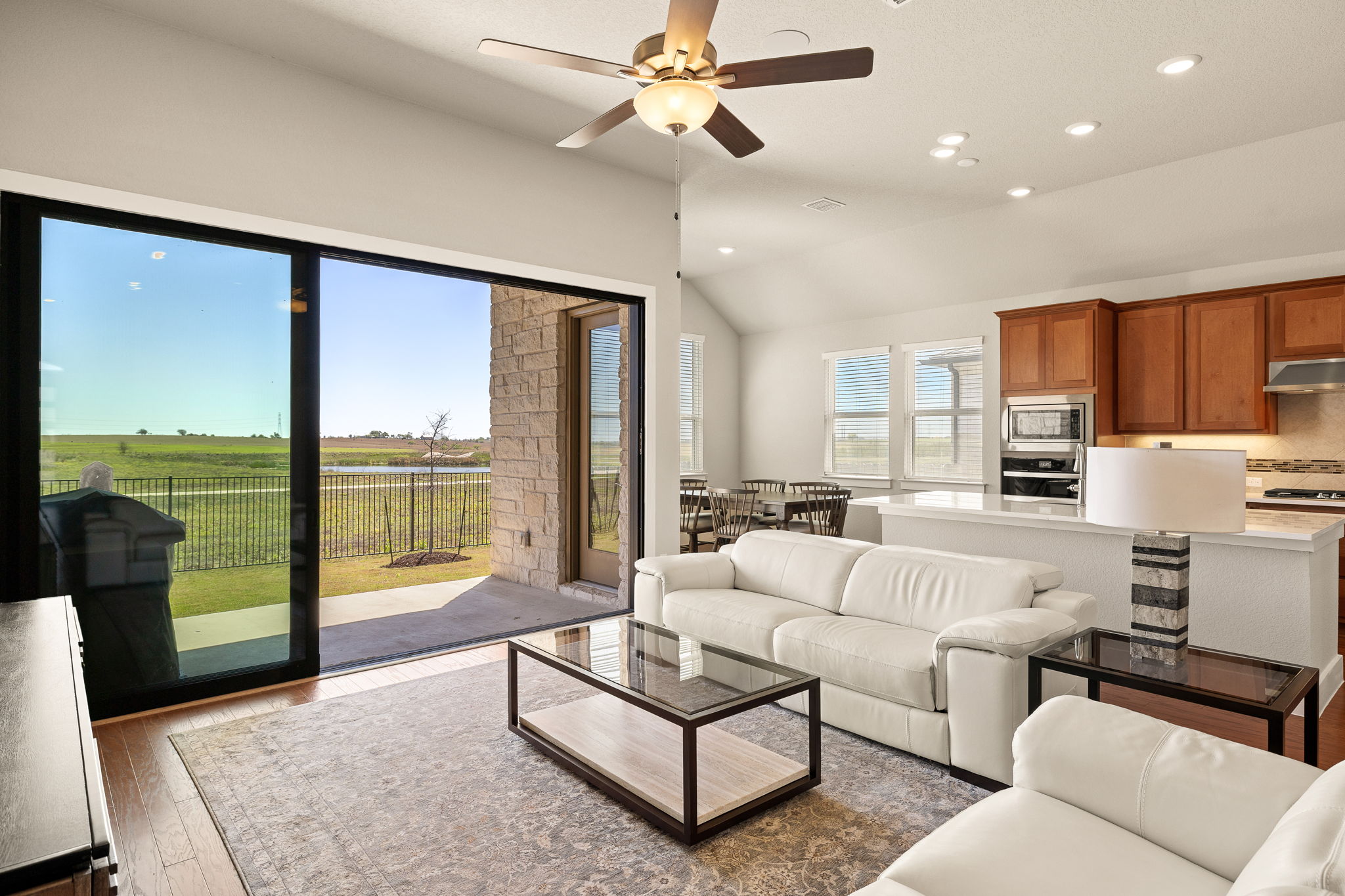 20409 Dustin Lane Pflugerville, TX 78660 - Photo 6 of 35 a living room with furniture and a large window with kitchen view