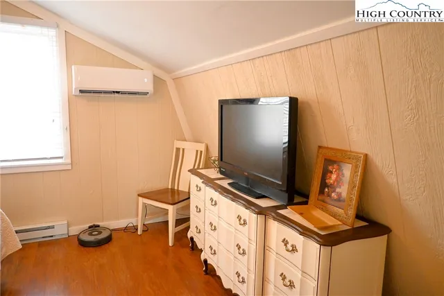 a living room with furniture and flat screen tv