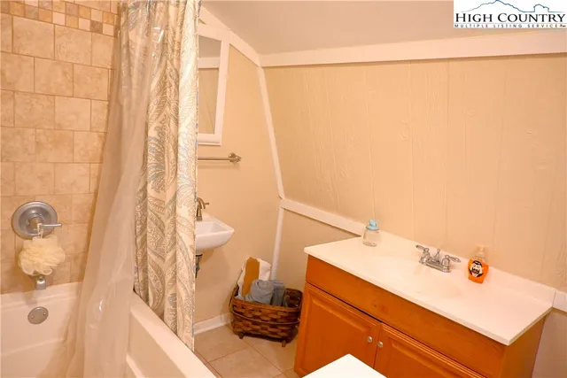 a bathroom with a bathtub and shower