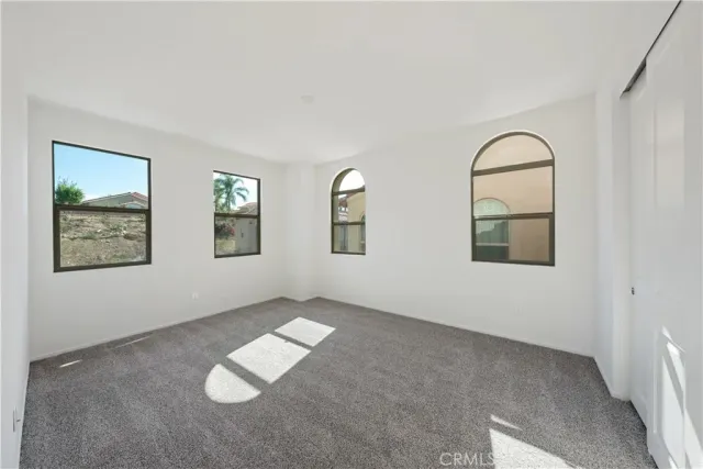 a view of an empty room with windows