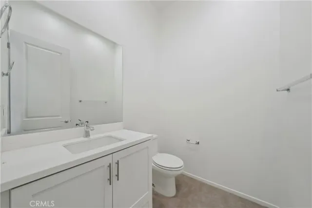 a bathroom with a sink mirror and toilet