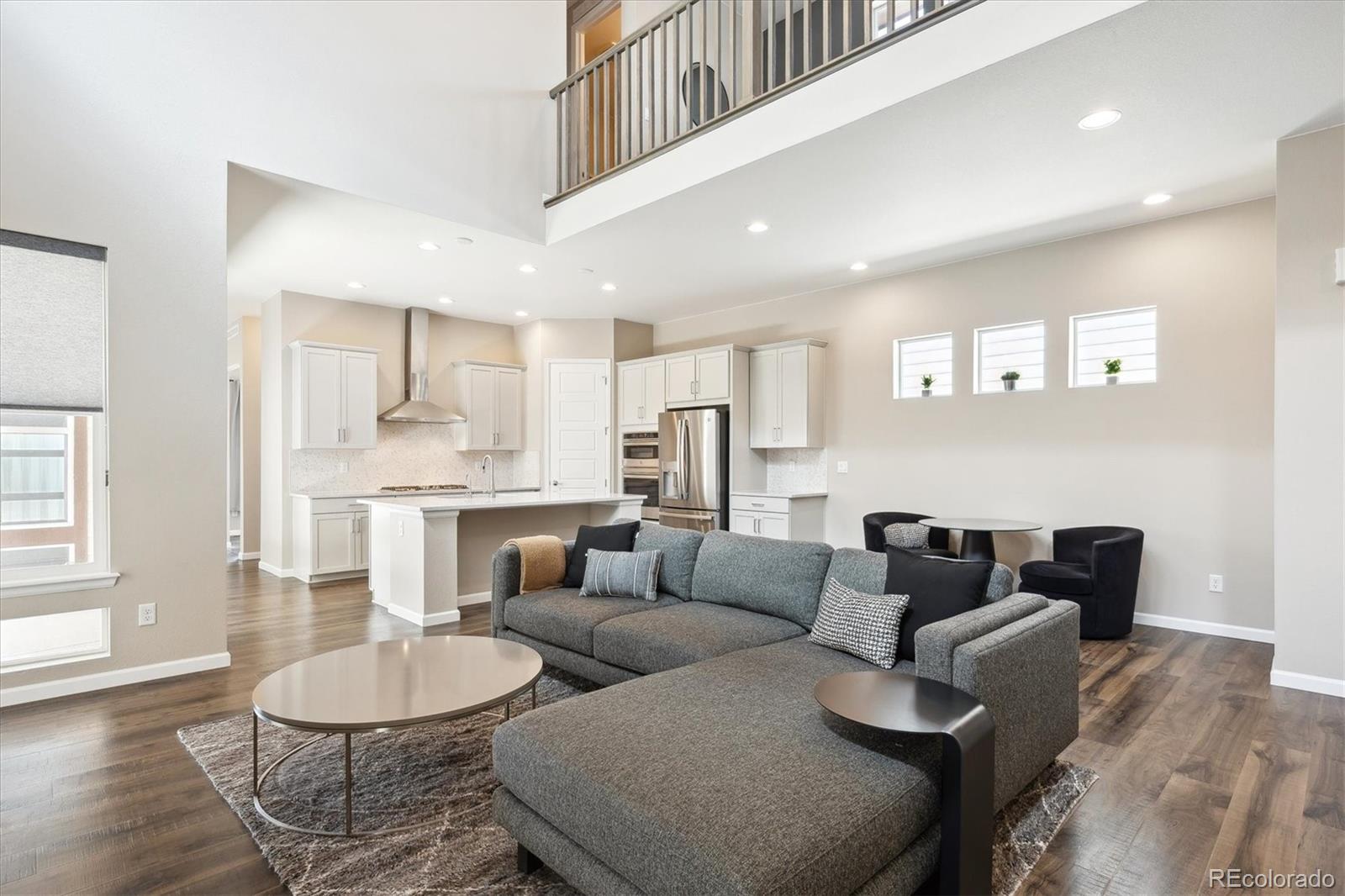 10557 Eby Circle Lone Tree, CO 80124 - Photo 11 of 50 a living room with furniture and a dining table with wooden floor