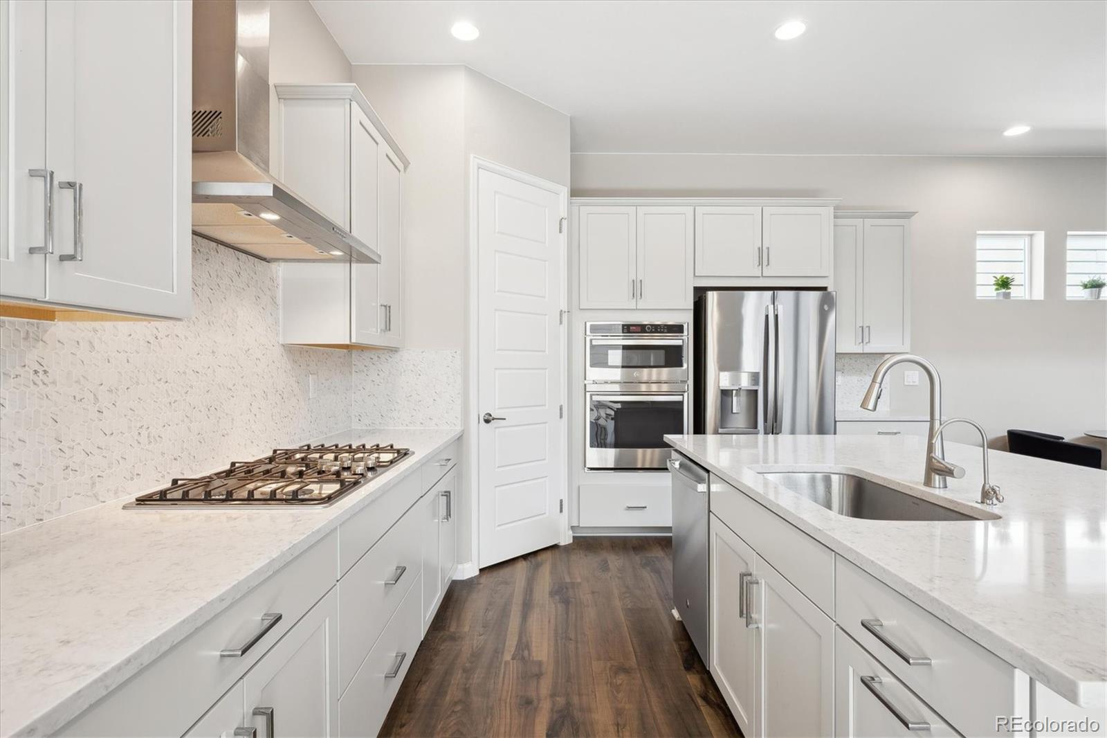 10557 Eby Circle Lone Tree, CO 80124 - Photo 14 of 50 a kitchen with stainless steel appliances a refrigerator sink and cabinets