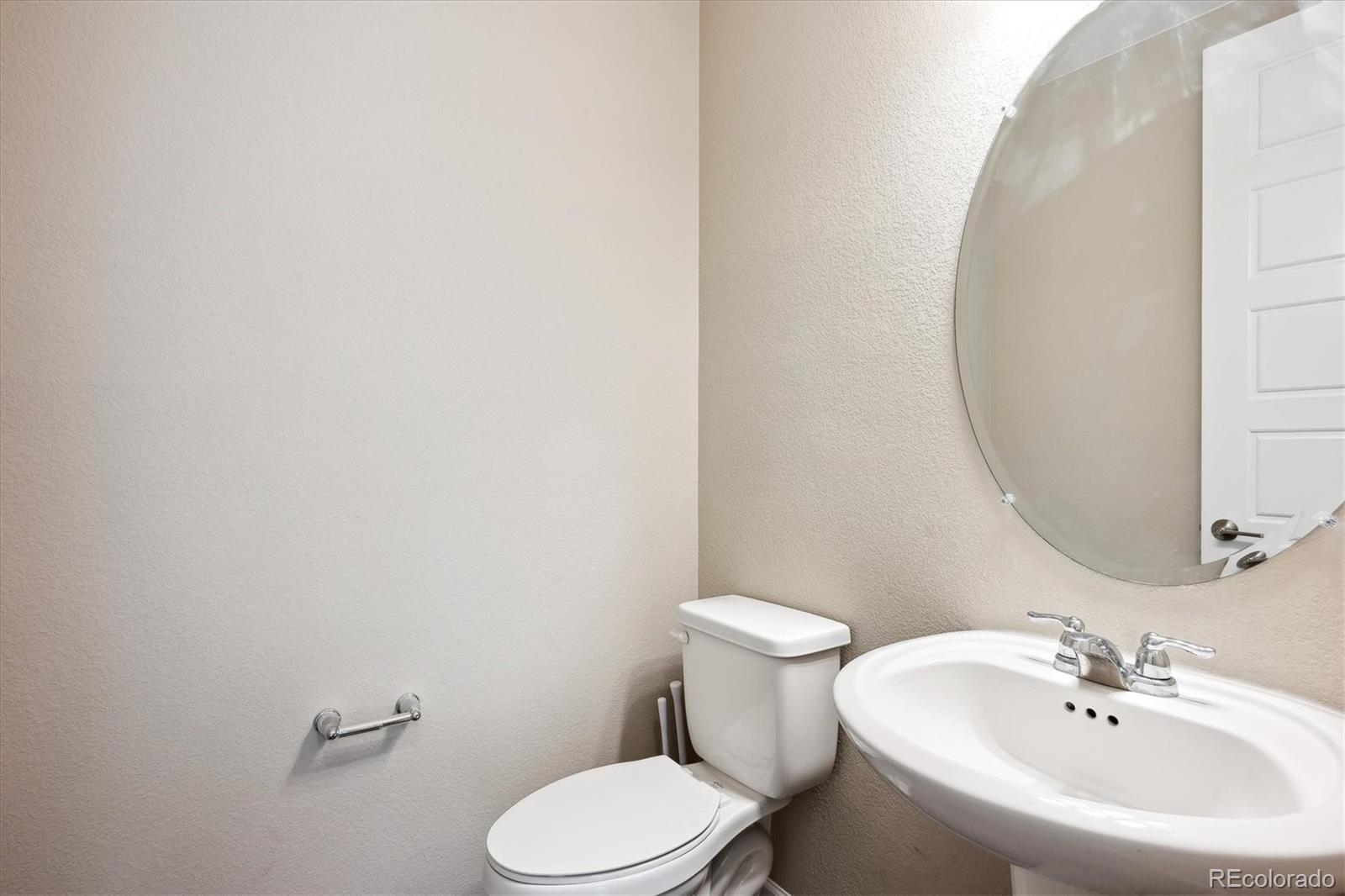 10557 Eby Circle Lone Tree, CO 80124 - Photo 21 of 50 a white toilet sitting next to a bathroom sink